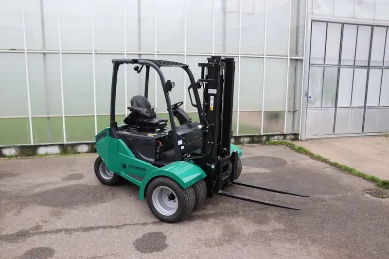 Green Prince Tiger XXL-E electric forklift outside in front of a greenhouse, right-rear view. - Prince Maasdijk